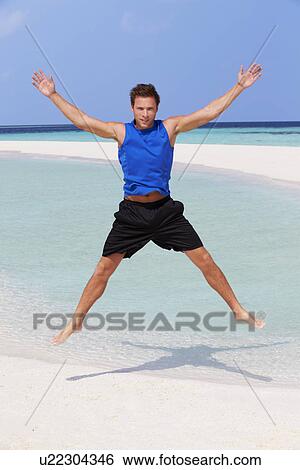 Stock Photograph - Man Exercising On Beautiful Beach. Fotosearch