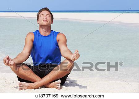 Stock Photo - Man Meditating On Beautiful Beach. Fotosearch