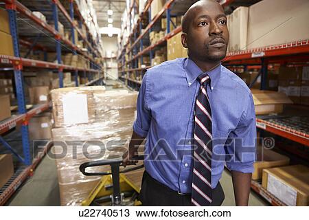 Man Pulling Pallet In Warehouse View Large Photo Image Stock Image - Man Pulling Pallet In Warehouse. Fotosearch