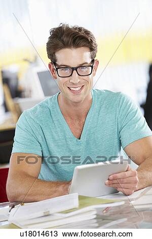 Man Using Digital Tablet In Busy Creative Office View Large Photo Image Stock Image - Man Using Digital Tablet In Busy Creative Office. Fotosearch