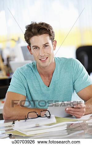 Man Using Digital Tablet In Busy Creative Office View Large Photo Image Stock Photograph - Man Using Digital Tablet In Busy Creative Office. Fotosearch