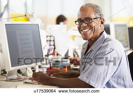 Man Working At Desk In Busy Creative Office View Large Photo Image Picture - Man Working At Desk In Busy Creative Office. Fotosearch