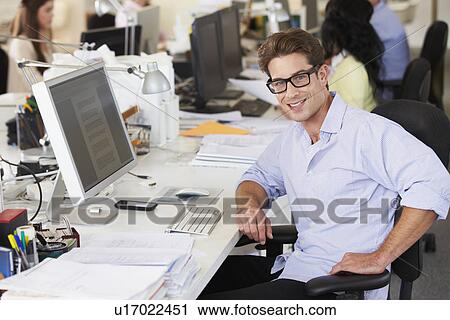 Man Working At Desk In Busy Creative Office View Large Photo Image Stock Image - Man Working At Desk In Busy Creative Office. Fotosearch