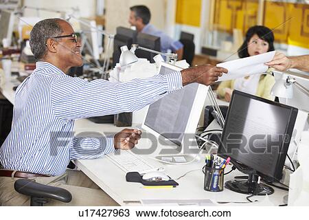 Man Working At Desk In Busy Creative Office View Large Photo Image Stock Image - Man Working At Desk In Busy Creative Office. Fotosearch