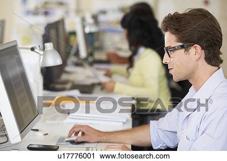 Man Working At Desk In Busy Creative Office View Large Photo Image Stock Image - Man Working At Desk In Busy Creative Office. Fotosearch