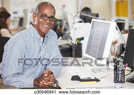 Man Working At Desk In Busy Creative Office View Large Photo Image Stock Image - Man Working At Desk In Busy Creative Office. Fotosearch