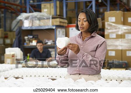 Picture - Manager Checking Goods On Production Line. Fotosearch