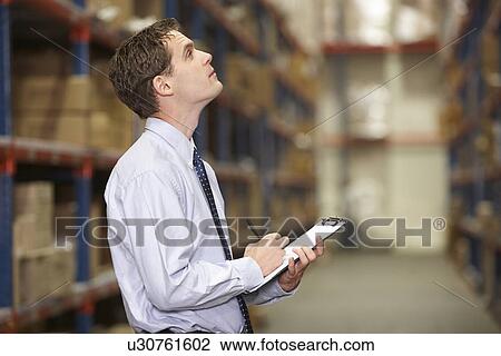Manager In Warehouse With Clipboard View Large Photo Image Stock Image - Manager In Warehouse With Clipboard. Fotosearch