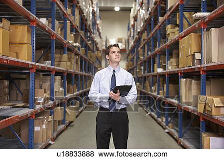 Manager In Warehouse With Clipboard View Large Photo Image Stock Photo - Manager In Warehouse With Clipboard. Fotosearch