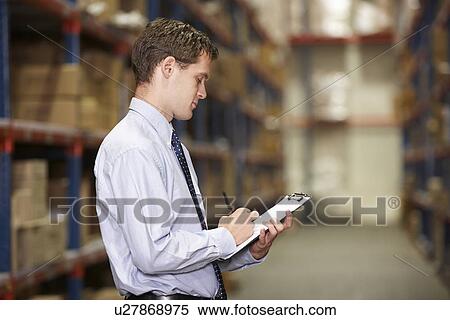 Stock Photography - Manager In Warehouse With Clipboard. Fotosearch