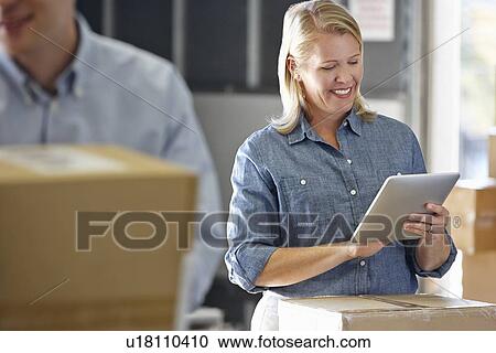 Manager Using Tablet Computer In Distribution Warehouse View Large Photo Image Stock Image - Manager Using Tablet Computer In Distribution Warehouse. Fotosearch