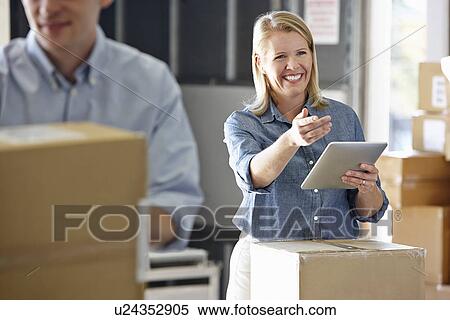 Manager Using Tablet Computer In Distribution Warehouse View Large Photo Image Stock Photography - Manager Using Tablet Computer In Distribution Warehouse. Fotosearch