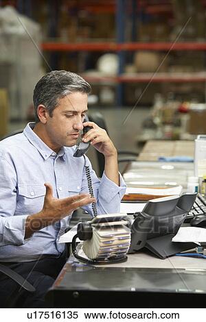 Manager Working At Desk In Warehouse View Large Photo Image Stock Photography - Manager Working At Desk In Warehouse. Fotosearch