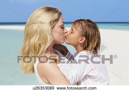 Stock Photo - Mother And Daughter Hugging On Beautiful Beach . Fotosearch