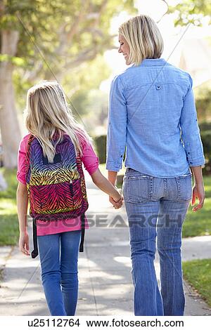 Picture - Mother And Daughter Walking To School On Suburban Street. Fotosearch