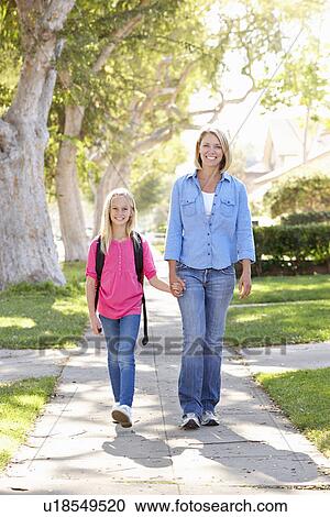 Mother And Daughter Walking To School On Suburban Street View Large Photo Image Stock Image - Mother And Daughter Walking To School On Suburban Street. Fotosearch