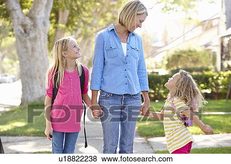 Mother And Daughters Walking To School On Suburban Street View Large Photo Image Stock Photo - Mother And Daughters Walking To School On Suburban Street. Fotosearch