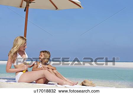 Mother Protecting Daughter With Sun Lotion On Beach Holiday View Large Photo Image Stock Image - Mother Protecting Daughter With Sun Lotion On Beach Holiday. Fotosearch