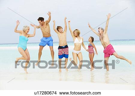 Multi Generation Family Having Fun In Sea On Beach Holiday View Large Photo Image Picture - Multi Generation Family Having Fun In Sea On Beach Holiday. Fotosearch