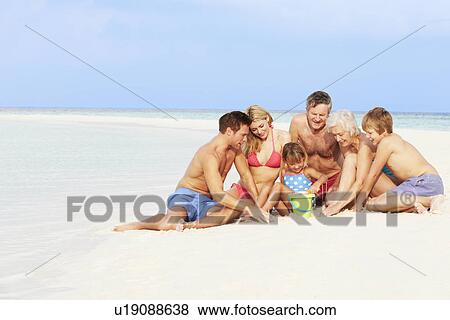 Multi Generation Family Having Fun On Beach Holiday View Large Photo Image Stock Photo - Multi Generation Family Having Fun On Beach Holiday. Fotosearch