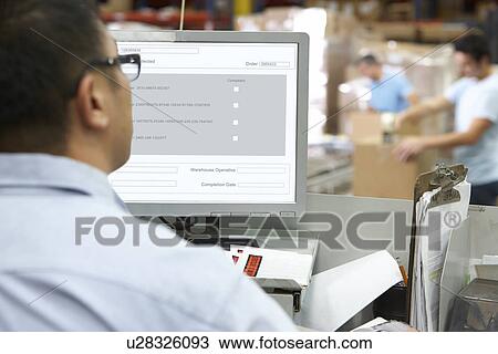 Person At Computer Terminal In Distribution Warehouse View Large Photo Image Stock Image - Person At Computer Terminal In Distribution Warehouse. Fotosearch