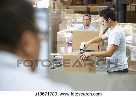 Person At Computer Terminal In Distribution Warehouse View Large Photo Image Stock Photo - Person At Computer Terminal In Distribution Warehouse. Fotosearch