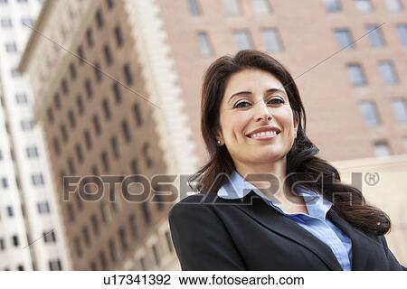 Stock Image - Portrait Of Businesswoman Standing In Street. Fotosearch
