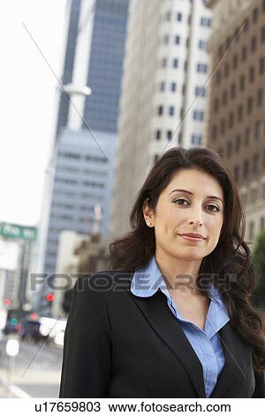 Stock Image - Portrait Of Businesswoman Standing In Street. Fotosearch