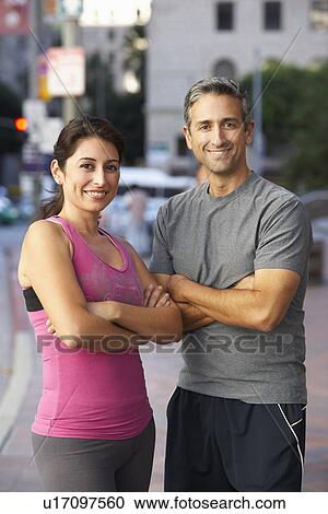 Stock Image - Portrait Of Male And Female Runners On Urban Street. Fotosearch