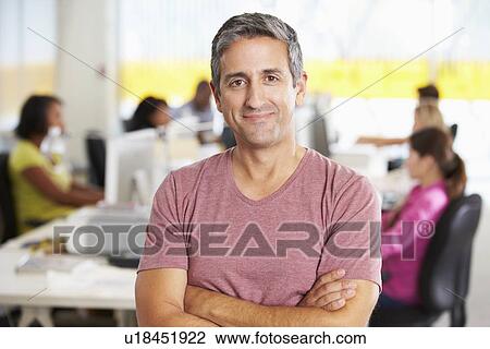 Portrait Of Man Standing In Busy Creative Office View Large Photo Image Stock Image - Portrait Of Man Standing In Busy Creative Office. Fotosearch