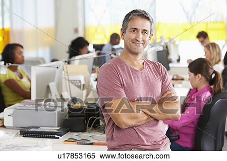 Portrait Of Man Standing In Busy Creative Office View Large Photo Image Stock Photography - Portrait Of Man Standing In Busy Creative Office. Fotosearch