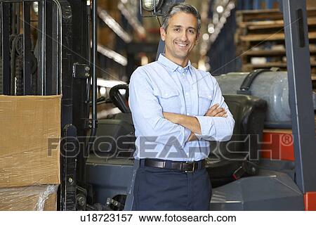 Portrait Of Man With Fork Lift Truck In Warehouse View Large Photo Image Stock Photo - Portrait Of Man With Fork Lift Truck In Warehouse. Fotosearch