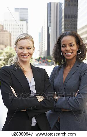 Stock Photo - Portrait Of Two Businesswomen Outside Office. Fotosearch