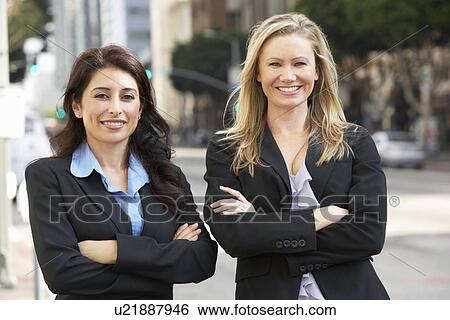 Stock Photograph - Portrait Of Two Businesswomen Outside Office. Fotosearch