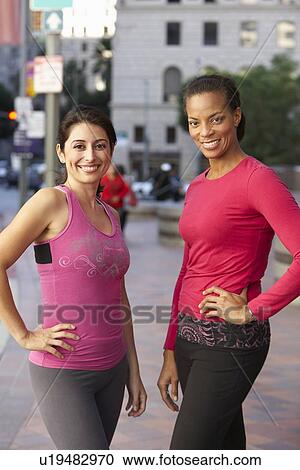 Stock Image - Portrait Of Two Female Runners On Urban Street. Fotosearch