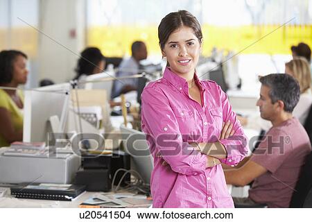 Portrait Of Woman Standing In Busy Creative Office View Large Photo Image Picture - Portrait Of Woman Standing In Busy Creative Office. Fotosearch