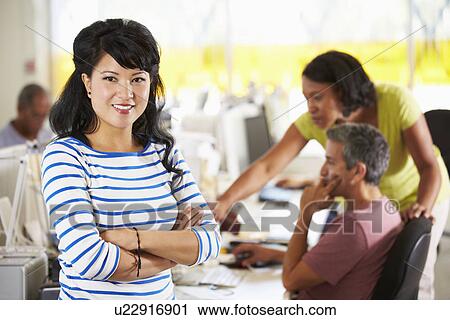 Portrait Of Woman Standing In Busy Creative Office View Large Photo Image Stock Image - Portrait Of Woman Standing In Busy Creative Office. Fotosearch