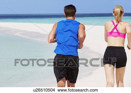 Rear View Of Couple Running On Beautiful Beach View Large Photo Image Picture - Rear View Of Couple Running On Beautiful Beach. Fotosearch