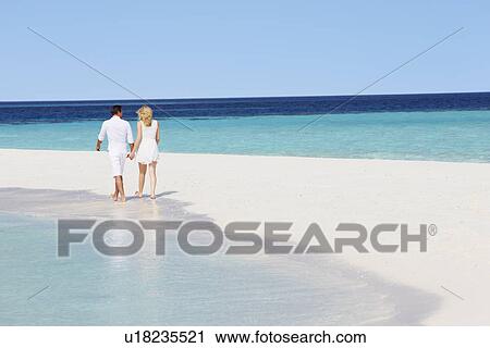 Rear View Of Romantic Couple Walking On Tropical Beach View Large Photo Image Stock Image - Rear View Of Romantic Couple Walking On Tropical Beach. Fotosearch