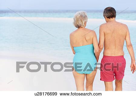 Rear View Of Senior Romantic Couple Walking In Tropical Sea View Large Photo Image Stock Photo - Rear View Of Senior Romantic Couple Walking In Tropical Sea. Fotosearch