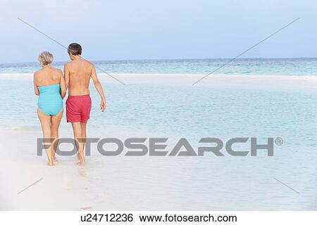 Rear View Of Senior Romantic Couple Walking In Tropical Sea View Large Photo Image Stock Photograph - Rear View Of Senior Romantic Couple Walking In Tropical Sea. Fotosearch
