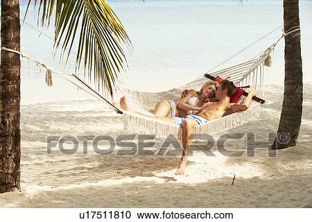 Romantic Couple Relaxing In Beach Hammock View Large Photo Image Stock Image - Romantic Couple Relaxing In Beach Hammock. Fotosearch