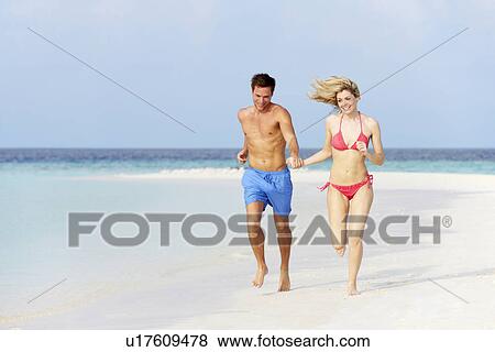 Romantic Couple Running On Beautiful Tropical Beach View Large Photo Image Stock Photo - Romantic Couple Running On Beautiful Tropical Beach. Fotosearch