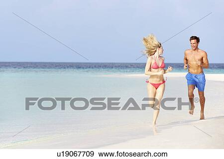 Romantic Couple Running On Beautiful Tropical Beach View Large Photo Image Stock Photo - Romantic Couple Running On Beautiful Tropical Beach. Fotosearch