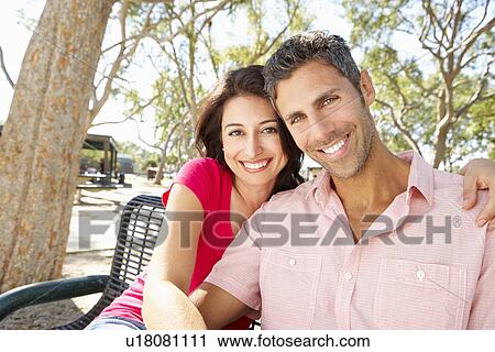 Romantic Couple Sitting On Park Bench Together View Large Photo Image Stock Image - Romantic Couple Sitting On Park Bench Together. Fotosearch