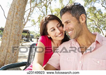 Romantic Couple Sitting On Park Bench Together View Large Photo Image Stock Image - Romantic Couple Sitting On Park Bench Together. Fotosearch