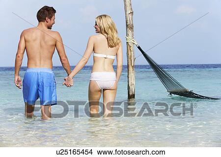 Picture - Romantic Couple Standing In Beautiful Tropical Sea. Fotosearch
