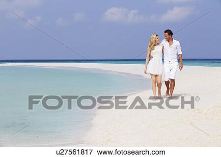 Romantic Couple Walking On Beautiful Tropical Beach View Large Photo Image Stock Photo - Romantic Couple Walking On Beautiful Tropical Beach. Fotosearch