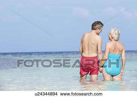 Picture - Romantic Senior Couple Standing In Beautiful Tropical Sea. Fotosearch
