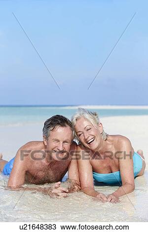 Senior Couple Enjoying Beach Holiday View Large Photo Image Stock Image - Senior Couple Enjoying Beach Holiday. Fotosearch